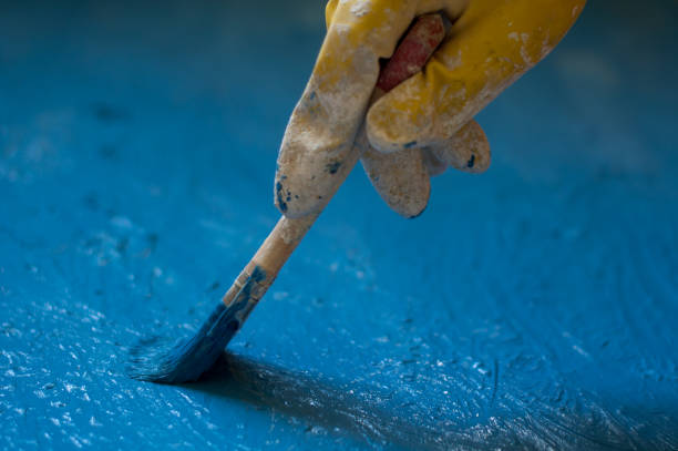 istock hand in glove yellow painted blue with bone, close up 665638136