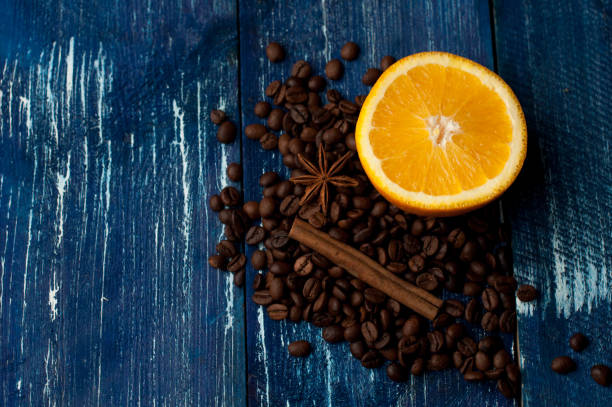 istock Aromatic composition of oranges, cinnamon and coffee beans on a dark blue background. Top view 665638346
