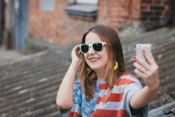 istock A hippest girl in an old courtyard with a phone makes a selfie 665641370