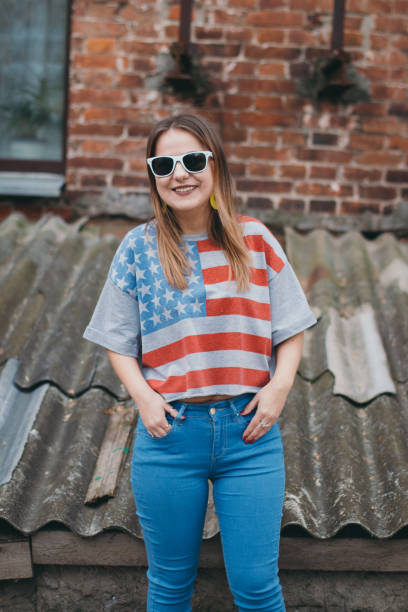 istock A hipster girl in an old courtyard posing and smiling 665641500