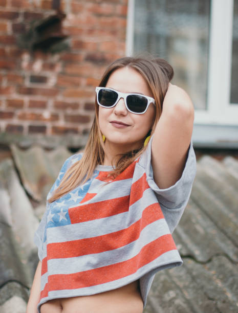 istock A hipster girl in an old courtyard posing and smiling 665641650