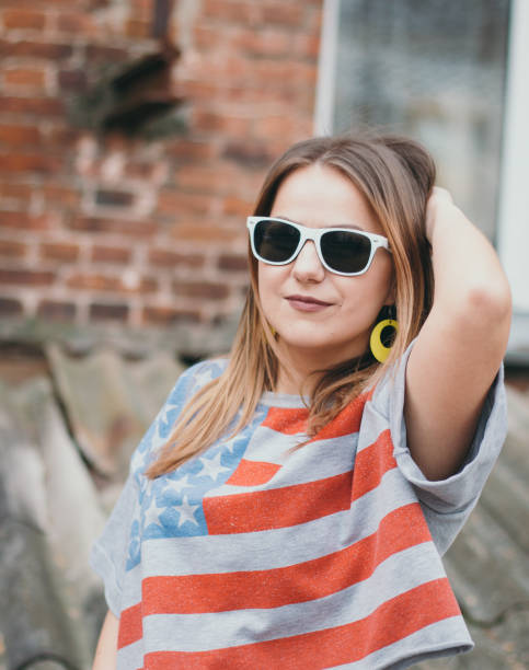 istock A hipster girl in an old courtyard posing and smiling 665641692