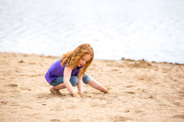 istock Girl Playing on Beach in Early Springtime 665641704
