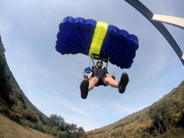 istock Basejumper landing after jump from bridge 665644274