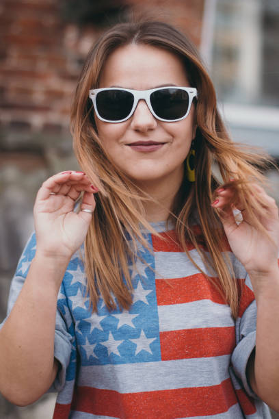 A hipster girl in an old courtyard posing and smiling