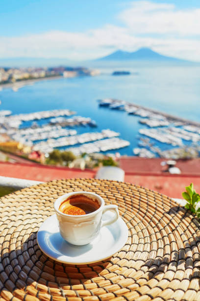 Cup of fresh espresso coffee in a cafe with view on Vesuvius mount in Naples, Campania, Southern Italy