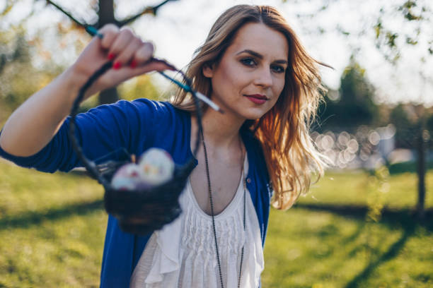 istock Beautiful girl decorating easter eggs with paint and decoupage technique 665647328