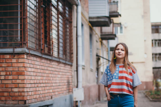 istock A hipster girl in an old courtyard posing and smiling 665647940