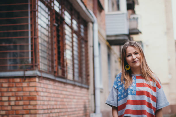istock A hipster girl in an old courtyard posing and smiling 665647982