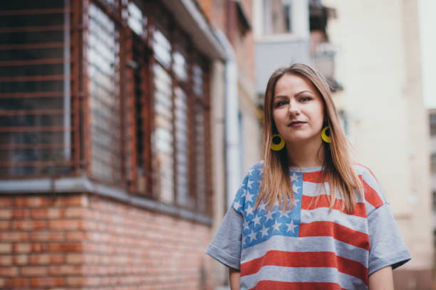 istock A hipster girl in an old courtyard posing and smiling 665648102