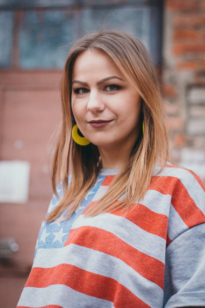 istock A hipster girl in an old courtyard posing and smiling 665648220