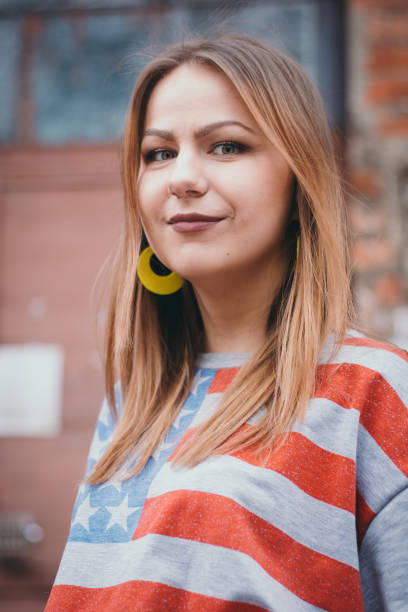 istock A hipster girl in an old courtyard posing and smiling 665648258