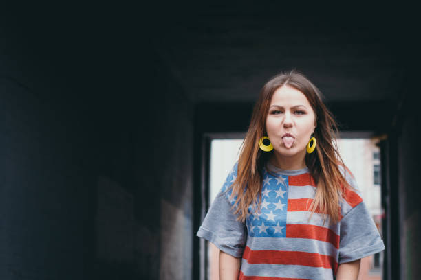 A hipster girl in an old courtyard posing and smiling