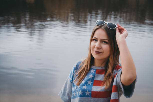 istock A girl hippy on the river bank posing and smiling 665648938