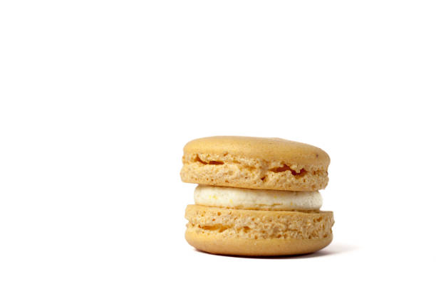 istock Tasty yellow macaron isolated on white 665653146