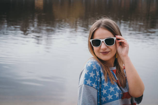 istock A girl hippy on the river bank posing and smiling 665653158