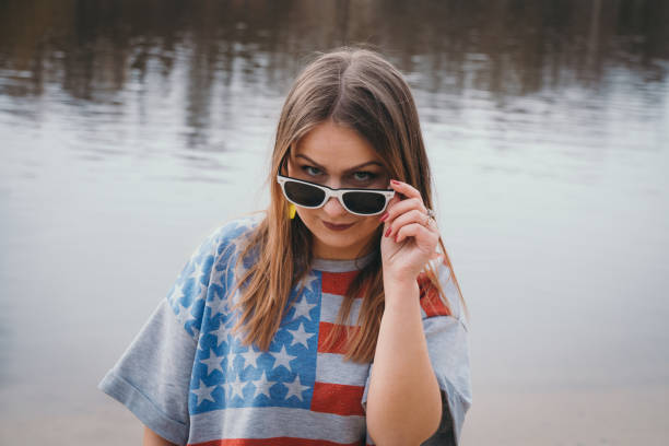 istock A girl hippy on the river bank posing and smiling 665653186