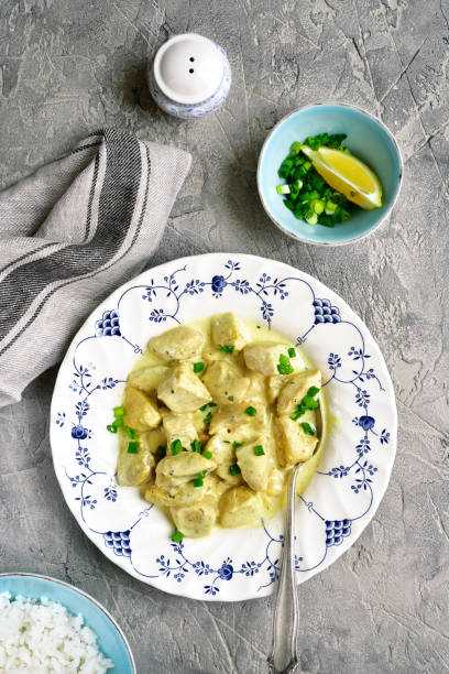 istock Chicken fricassee in a white sauce garnished with boiled rice 665656020