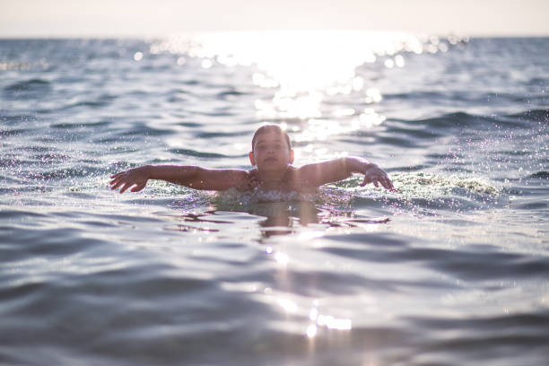 istock happy boy swimming in the ocean 665656806