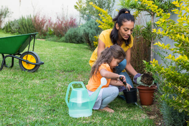 istock Smiling mother and daughter gardening 665663846