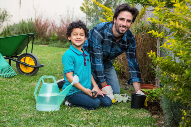 istock Smiling father and son gardening 665666008
