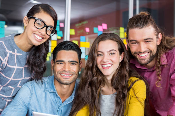 istock Smiling graphic designers discussing over digital tablet in office 665666128
