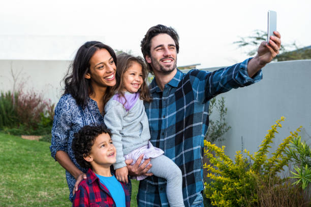 istock Smiling family taking selfie 665666266
