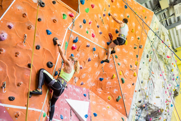 istock Fit couple rock climbing indoors 665666294