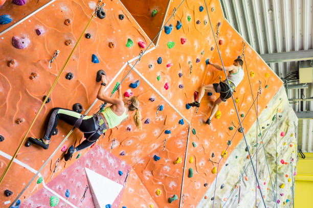 istock Fit couple rock climbing indoors 665666324