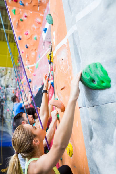 istock Fit people rock climbing indoors 665666600