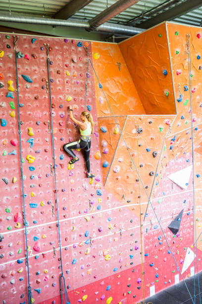 istock Fit woman rock climbing indoors 665666782