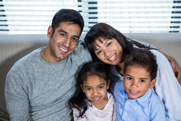 istock Happy young family posing together on the couch 665666914