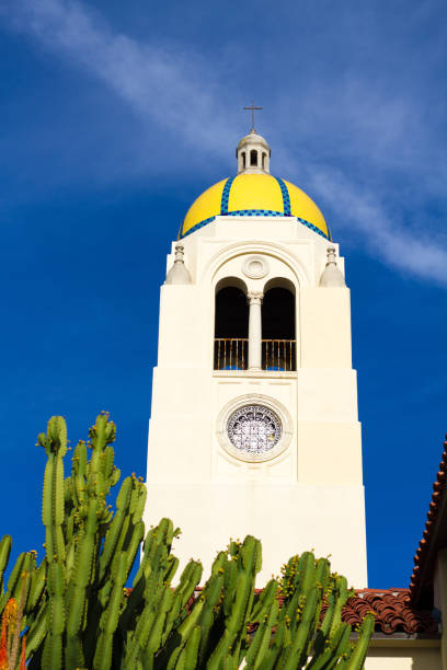 La Jolla, CA, USA: The tower at The Bishop's School, a historic landmark in downtown La Jolla, with a candelabra cactus in the foreground. Bright blue background; copy space available.