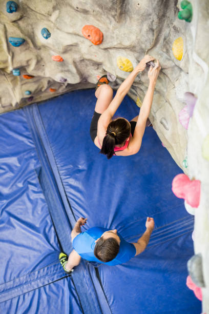 istock Fit couple rock climbing indoors 665667278