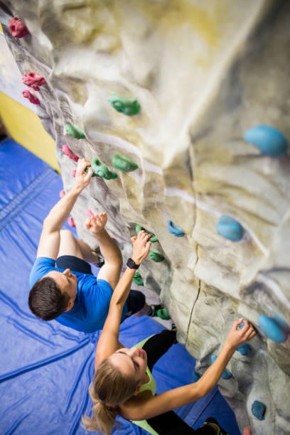 istock Fit woman rock climbing indoors 665667512