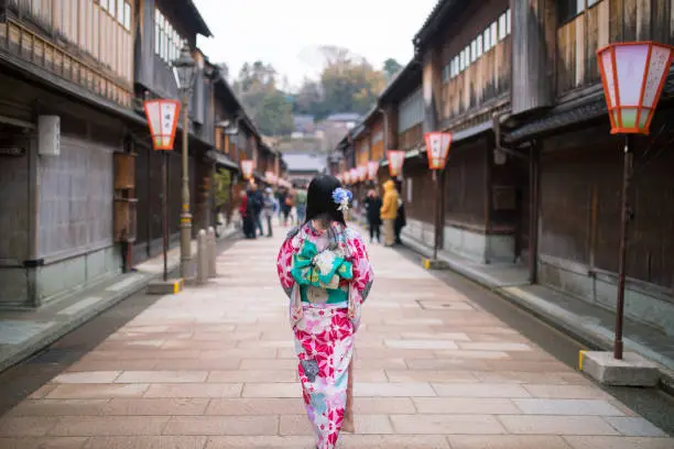 Young woman walking ing traditional Japanese shopping street