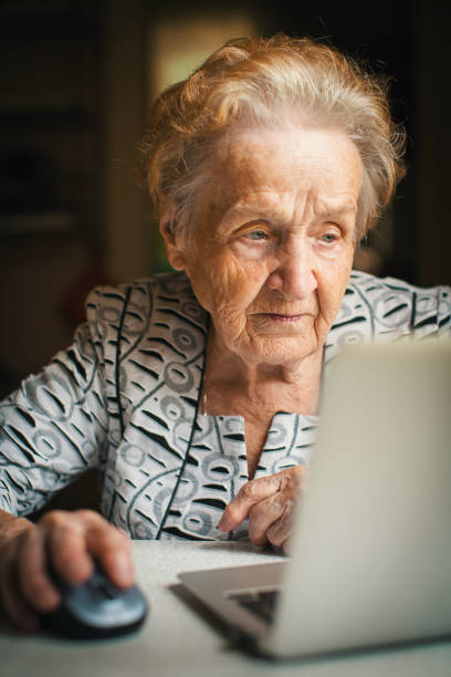 istock Retired woman working on computer at home. 665678444