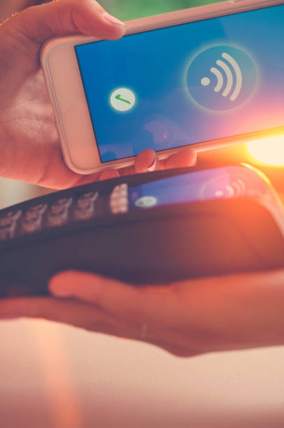 istock Woman paying with a mobile phone. 665681362