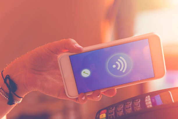 istock Woman paying with a mobile phone. 665681366