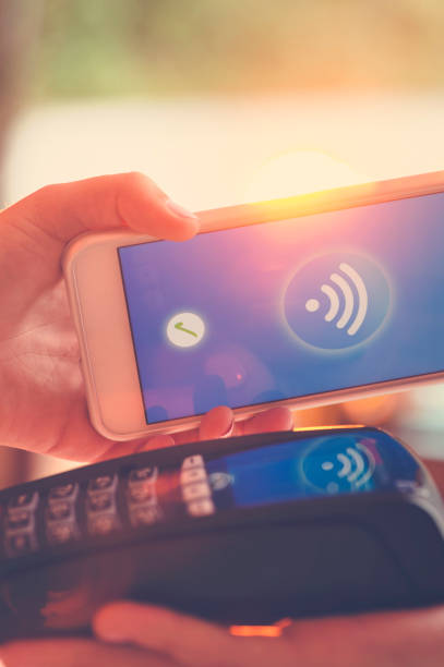 istock Woman paying with a mobile phone. 665681372