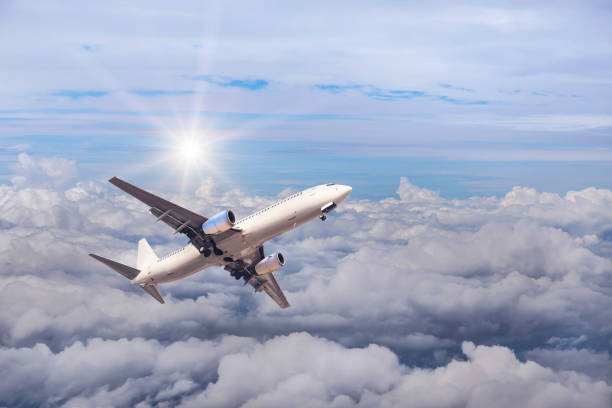 istock airplane flying in to sky above the white clouds 665684406