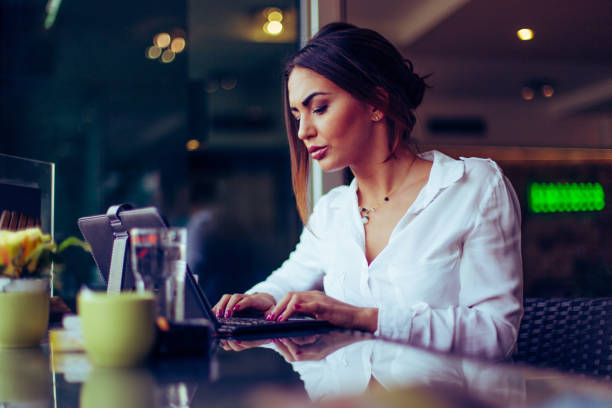 istock Businesswoman sitting in bar and working on digital tablet 665686474