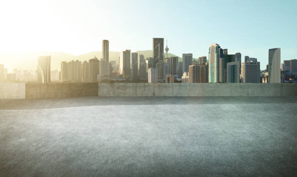 istock Empty asphalt carpark with modern city skyline , morning sunrise scene . 665686962