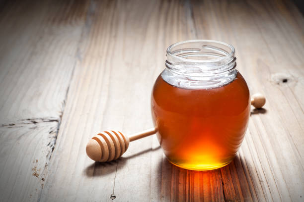 istock Glass jar of honey 665687358