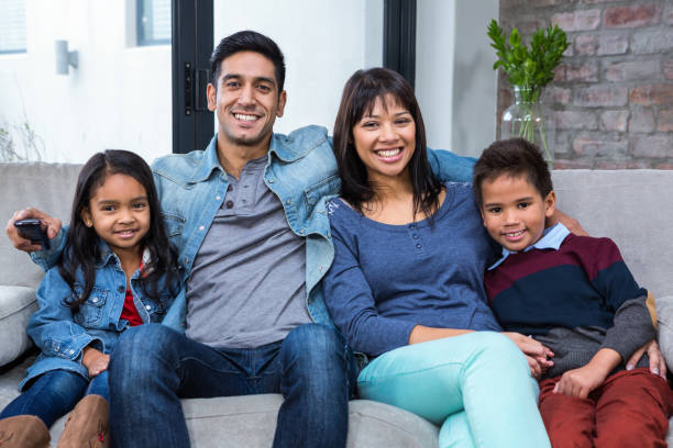 istock Happy young family watching tv 665689454
