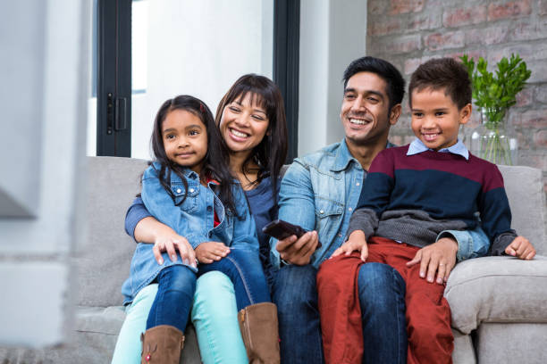 istock Happy young family watching tv 665689574