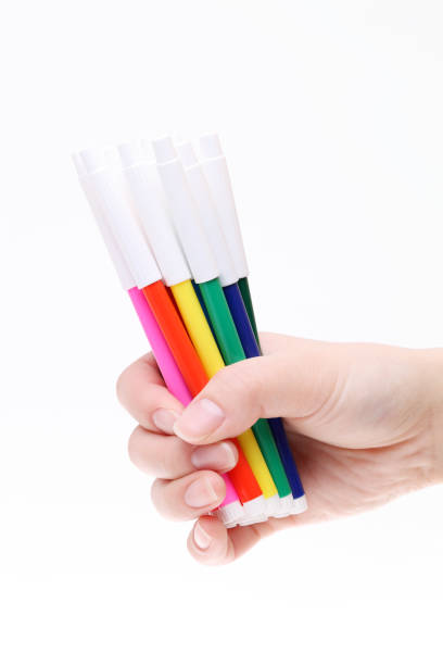 Hand holding colorful pens Hand holding colorful pens on a white background 書く stock pictures, royalty-free photos & images
