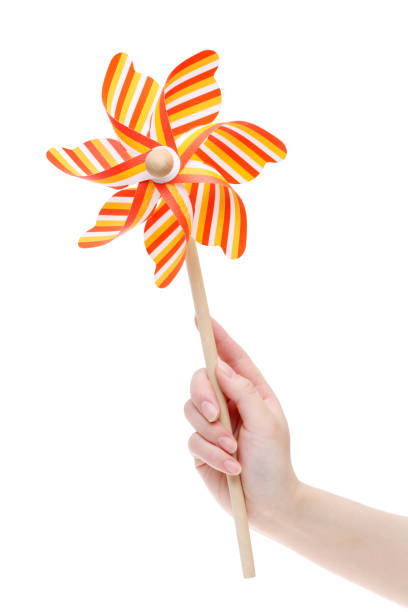 istock Hand holding colorful toy pinwheel 665695572