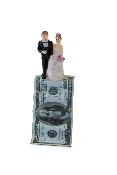 istock Wedding couple figurines on US dollar banknote 665696036