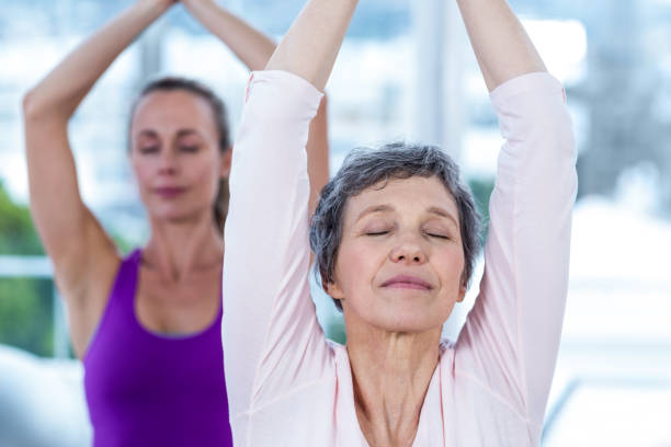 istock Women meditating with joined hands and eyes closed 665696132